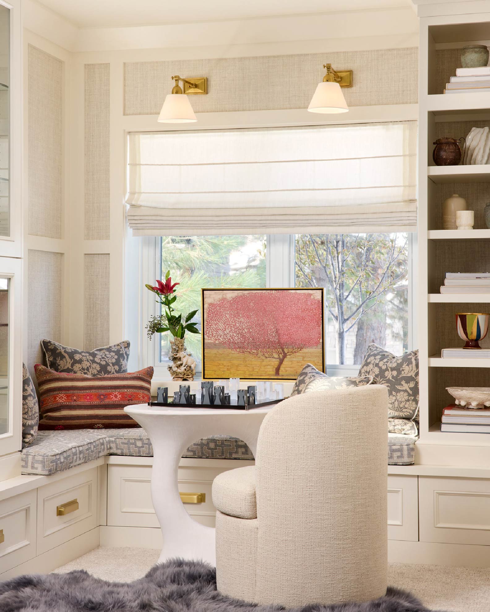 A stylish dining room with soft pink walls and a sparkling chandelier illuminating the space.
