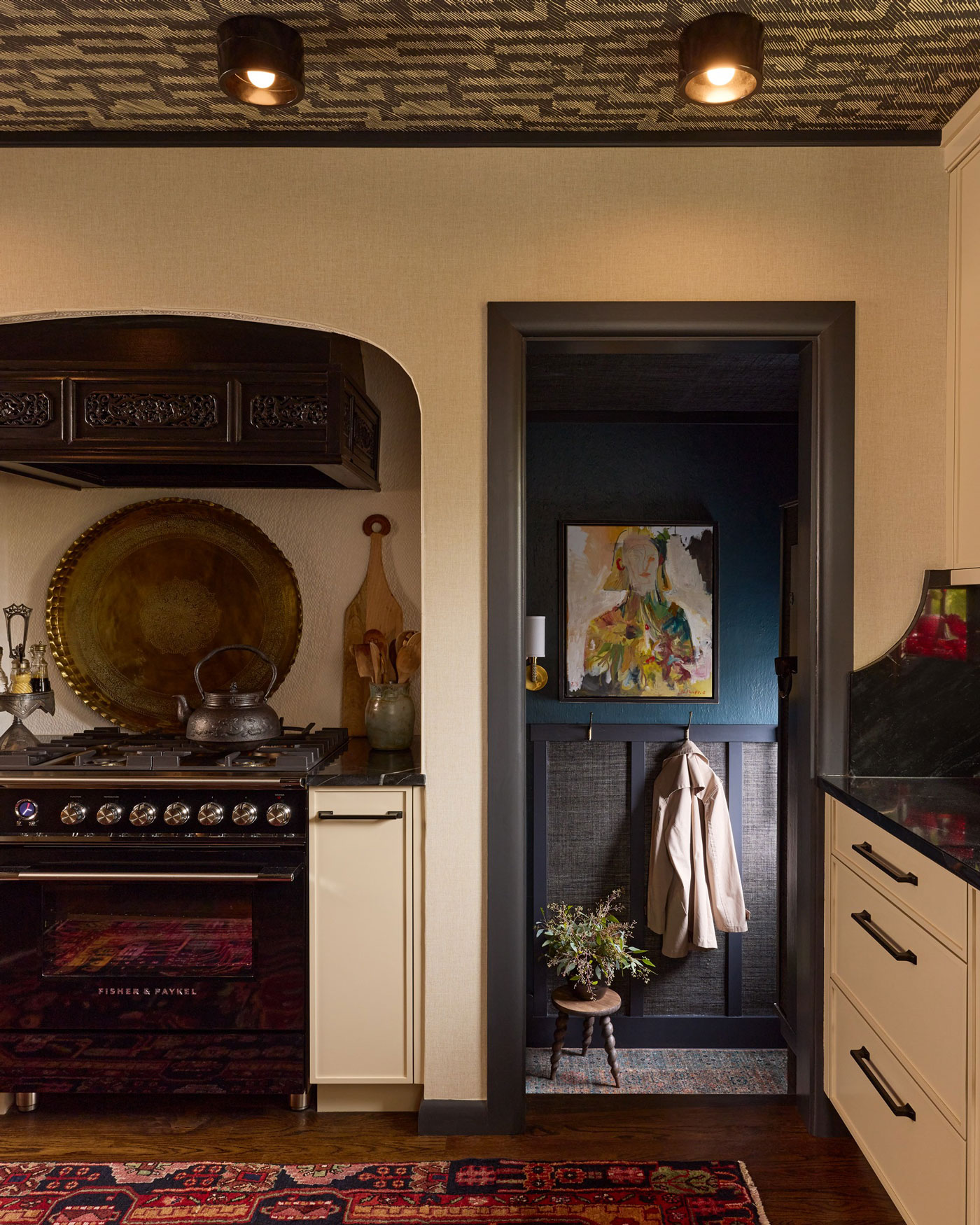 Chic dining area showcasing bold black and white tiles and a luxurious gold chandelier illuminating the space.